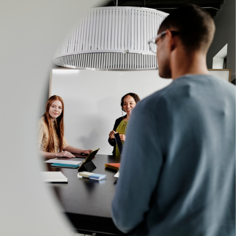 Colleagues strategize around a conference room table.